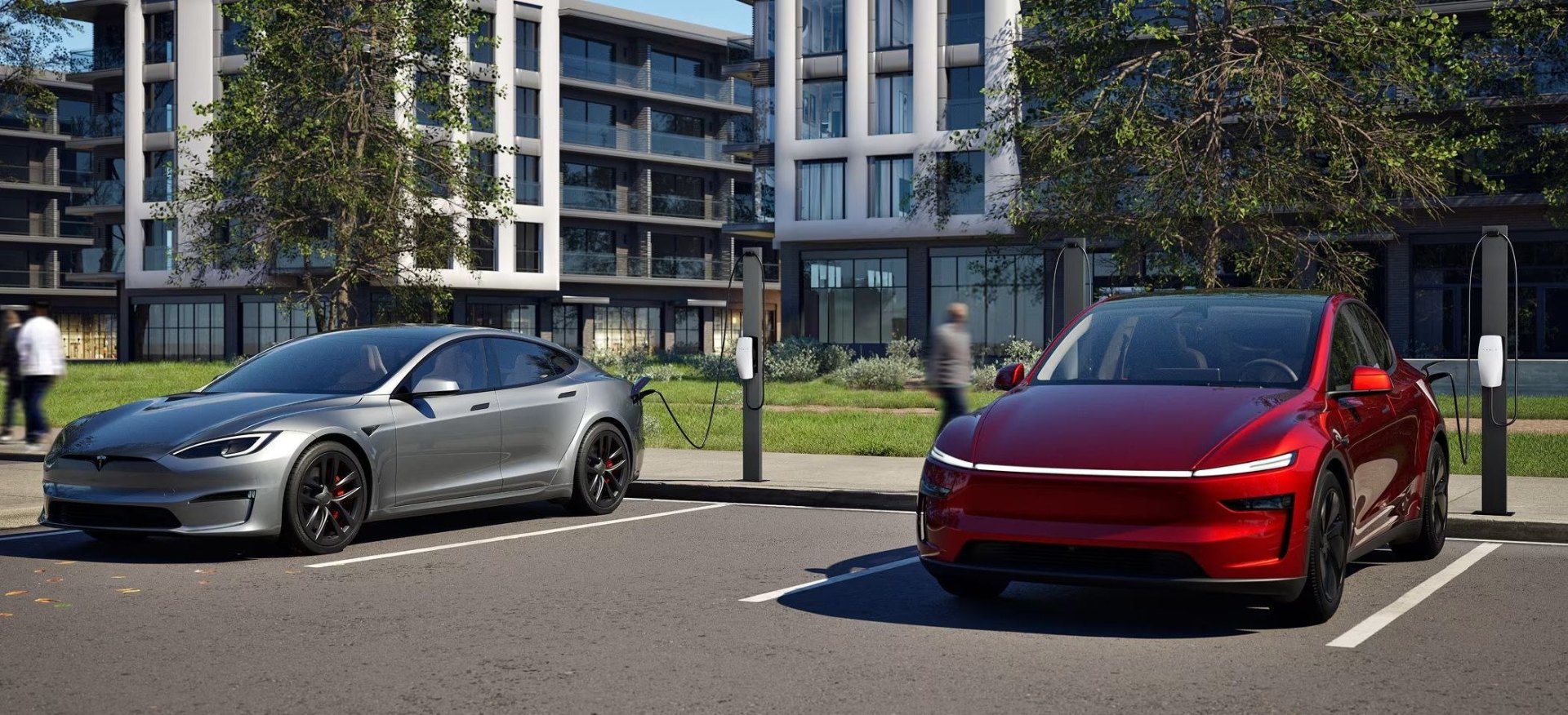Tesla Model S and Model X charging at pedestal connectors in front of an apartment community